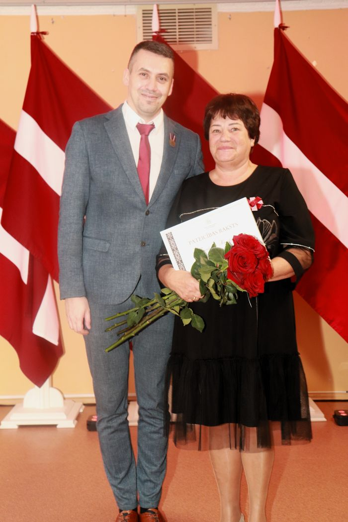 Apbalvojumu saņēmušais darbinieks bildē ar iestādes direktoru