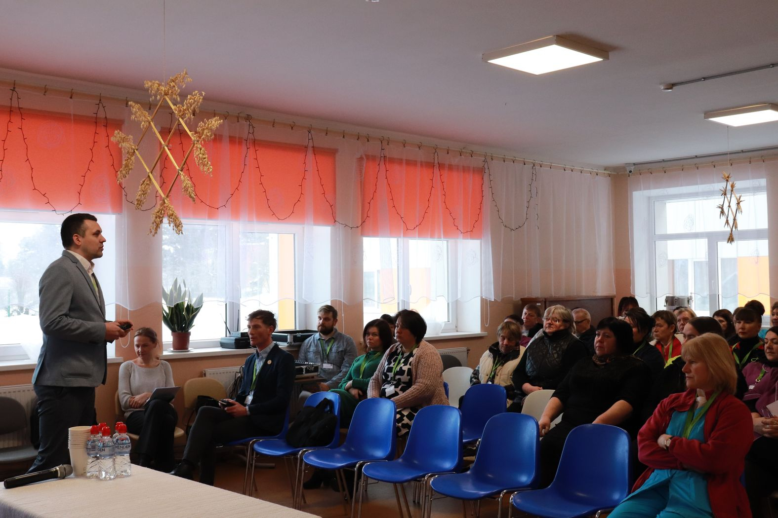 Zālē sēž darbinieki, priekšā iestādes direktors vada kopsapulci