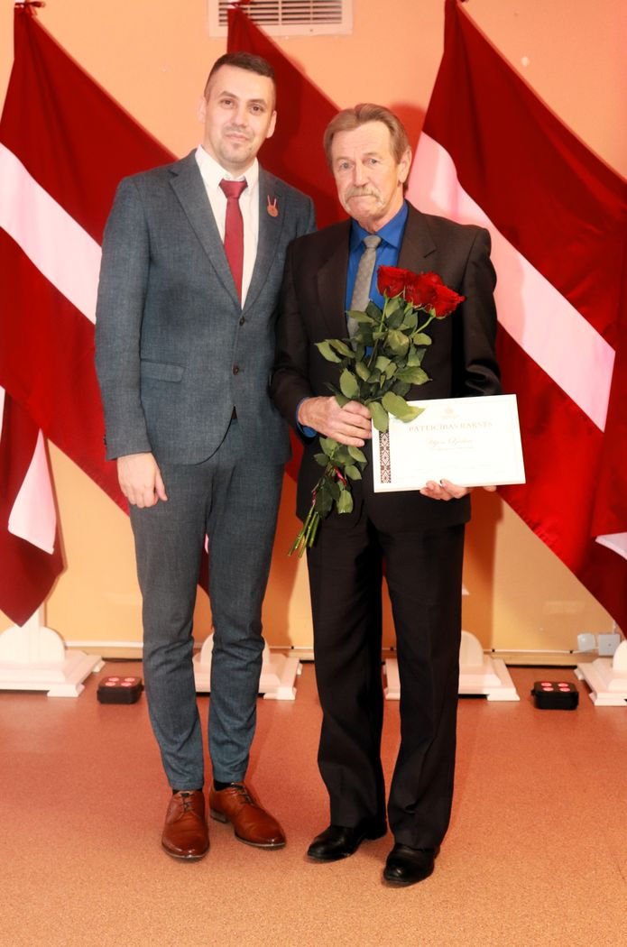 Apbalvojumu saņēmušais darbinieks bildē ar iestādes direktoru