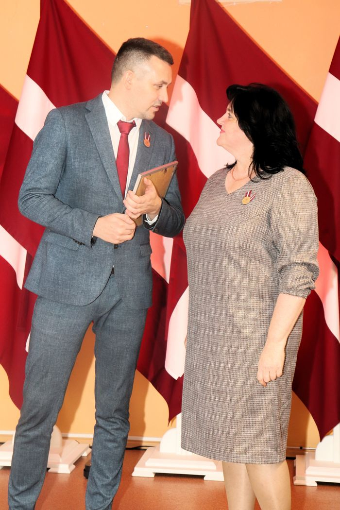 Apbalvojumu saņēmušais darbinieks bildē ar iestādes direktoru