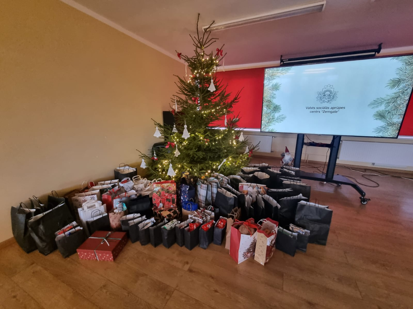 Zālē zem zZiemassvētku eglītes ir ļoti daudz dāvanu