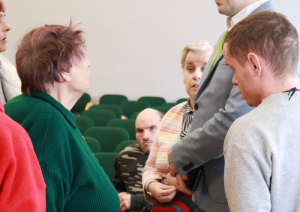 Iestādes direktors sarunājas ar iestādes iedzīvotājiem un atbild uz viņu jautājumiem